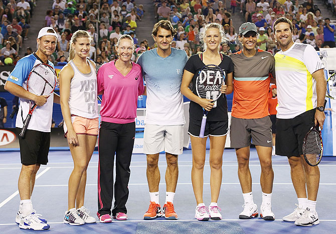 Lleyton Hewitt, Eugenie Bouchard, Samantha Stosur, Roger Federer, Victoria Azarenka, Rafael Nadal and Pat Rafter pose following the Rod Laver Arena Spectacular as part of Kids Tennis Day ahead of the 2014 Australian Open at Melbourne Park in Melbourne on Saturday