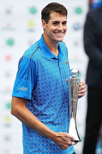 John Isner of United States poses with the trophy after winning the singles final against Yen- Hsun Lu of Taiwan in Auckland on Saturday