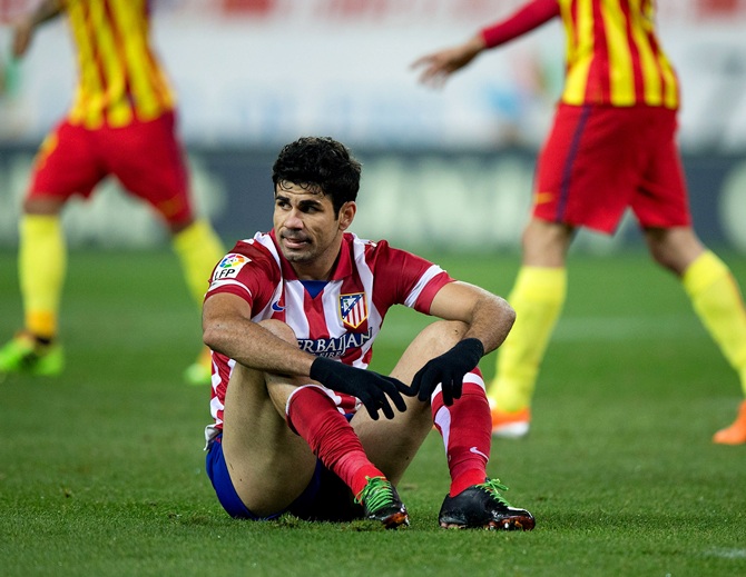 Diego Costa of Atletico de Madrid sits on the ground after failing to score