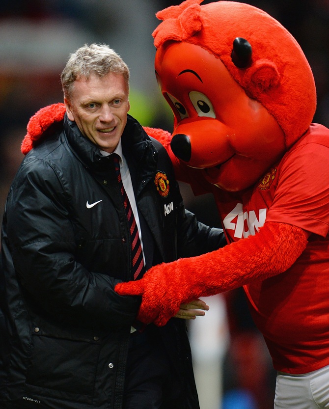 Manchester United Manager David Moyes is greeted by mascot Fred the Red