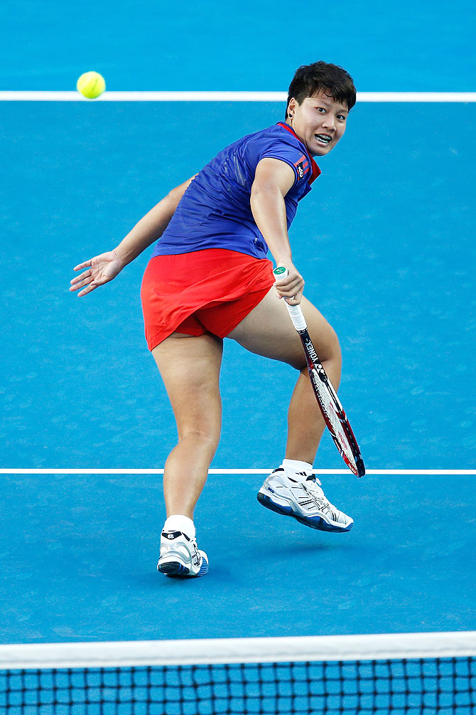 Luksika Kumkhum of Thailand plays a backhand in her first round match against Petra Kvitova of the Czech Republic on Monday