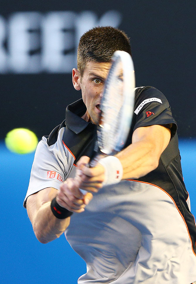Novak Djokovic of Serbia plays a backhand in his first round match against Lukas Lacko of Slovakia at the Australian Open