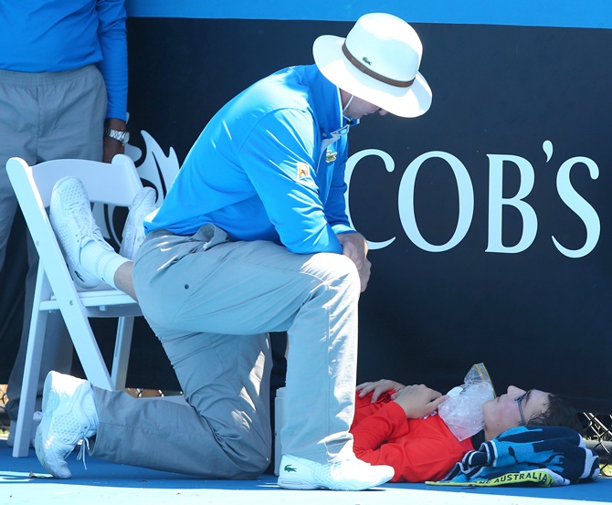 A ballboy faints in the heat, as Melbourne heads towards 43 degrees celsius