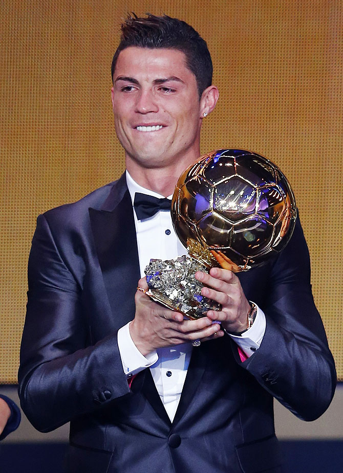 Portugal's Cristiano Ronaldo holds his trophy after being awarded the FIFA Ballon d'Or 2013 in Zurich in January