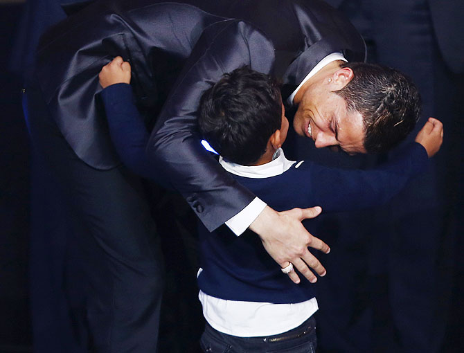 Portugal's Cristiano Ronaldo embraces his son Cristiano Ronaldo Jr after being awarded the FIFA Ballon d'Or 2013 in Zurich on Monday
