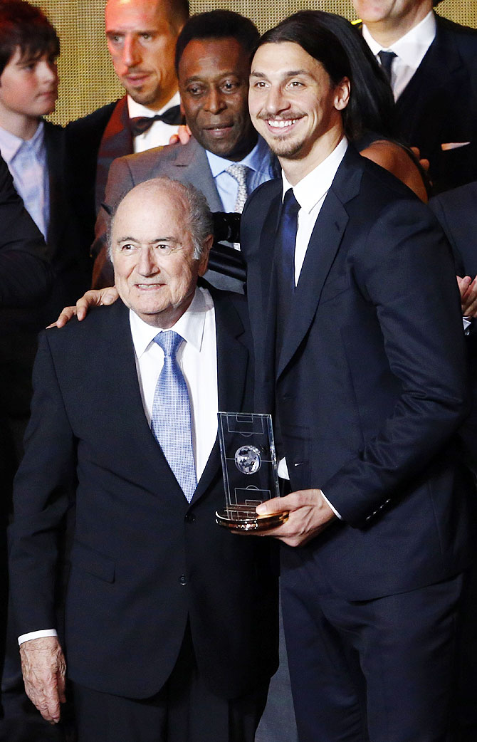 Sweden's Zlatan Ibrahimovic (right), winner of the FIFA Puskas Award for Goal of the Year, poses with FIFA President Sepp Blatter on Monday