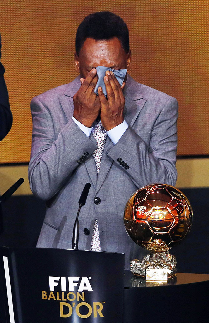 Pele reacts after receiving the FIFA honorary award or the Prix d'Honneur during the FIFA Ballon d'Or 2013 soccer awards ceremony on Monday
