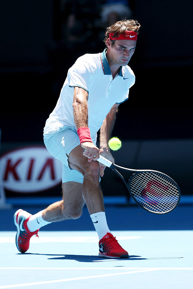 Roger Federer of Switzerland plays a backhand in his first round match against James Duckworth of Australia at the Australian Open at Melbourne Park on Tuesday