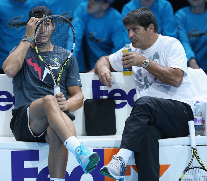 Rafael Nadal of Spain discusses tatics with his coach Toni Nadal