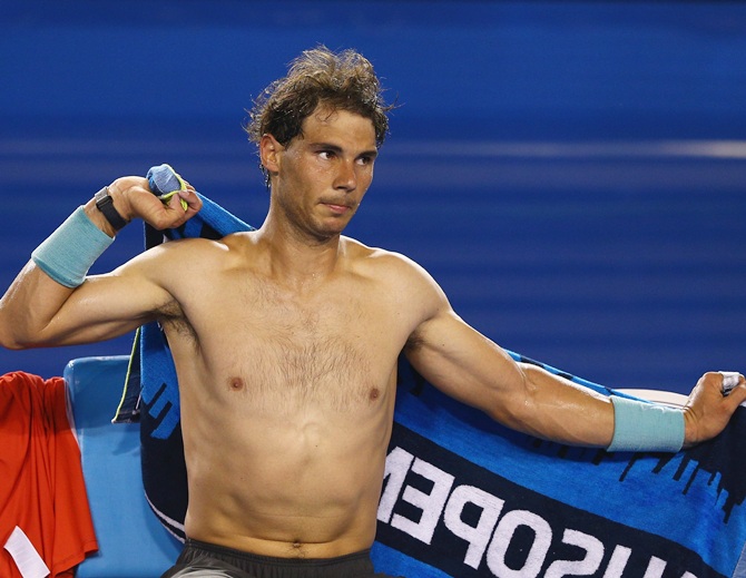Rafael Nadal of Spain dries off with a towel