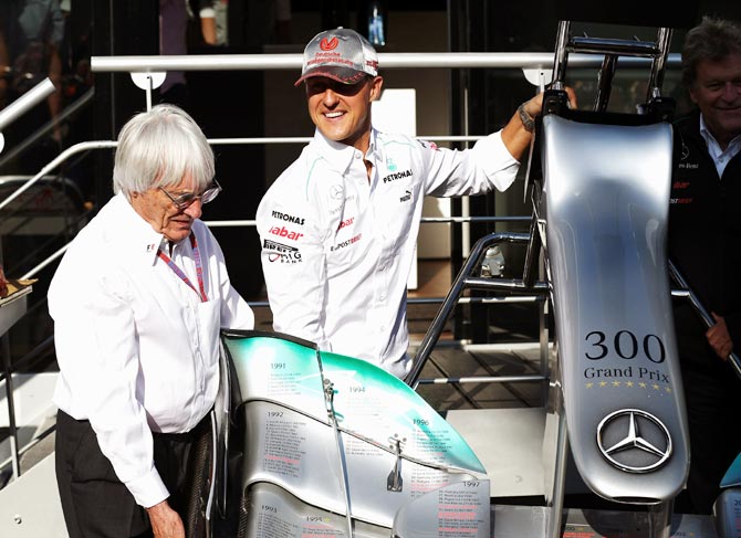 Bernie Ecclestone (left) with Michael Schumacher during qualifying for the 2012 Belgian Grand Prix