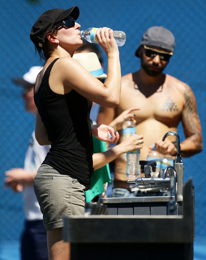 A tennis fan cools off at a water fountain as Melbourne heads towards 43 degrees celsius (109 degrees fahrenheit)   during day two of the 2014 Australian Open at Melbourne Park