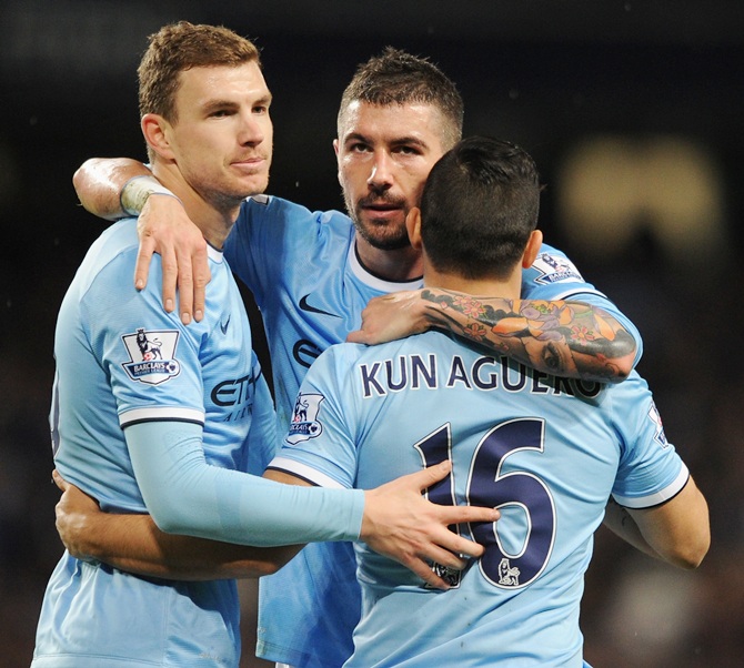 Sergio Aguero of Manchester City celebrates scoring his team's fourth goal with team-mates Edin Dzeko (left) and Aleksandar Kolarov