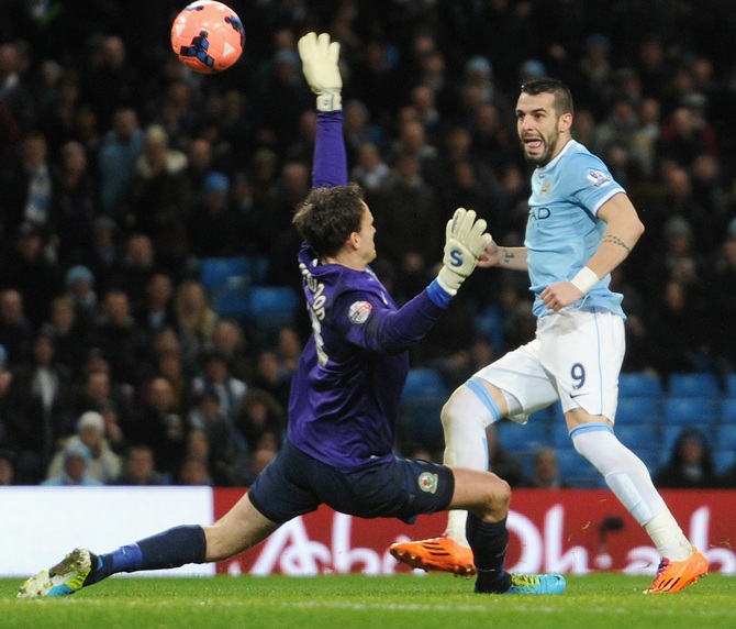 Alvaro Negredo of Manchester City scores the second goal past Simon Eastwood of Blackburn Rovers