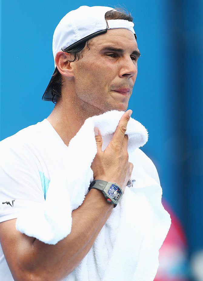 Rafael Nadal of Spain grimaces as he feels the heat