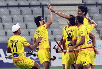 The Indian hockey team celebrates scoring a goal