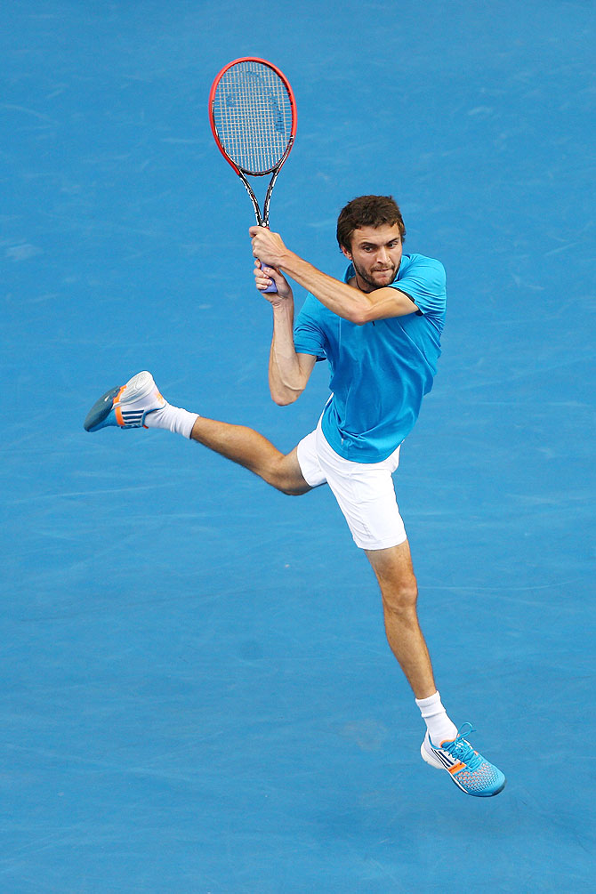 Gilles Simon of France plays a backhand in his third round match against compatriot Jo-Wilfried Tsonga on Saturday