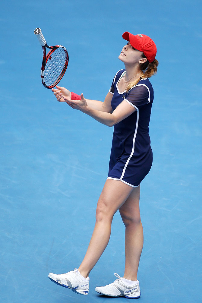 Alize Cornet of France throws her racquet in frustration during her match against Maria Sharapova of Russia at the Australian Open at Melbourne Park on Sunday