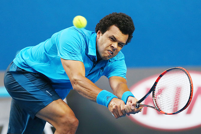 Jo-Wilfried Tsonga of France plays a backhand in his third round match against compatriot Gilles Simon on Saturday