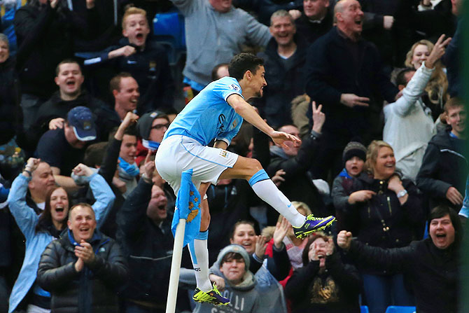 Jesus Navas of Manchester City celebrates after scoring against Cardiff City at the Etihad Stadium in Manchester on Saturday