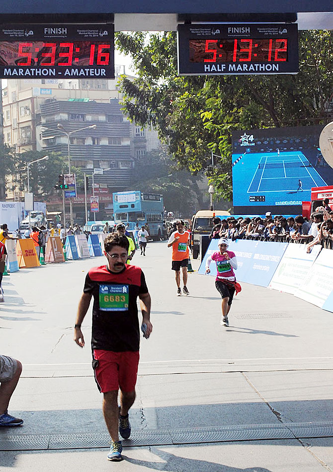 An amateur runner nears the finish line