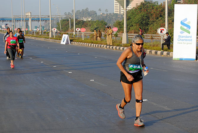 This old lady runs while the younger lot are seen walking during the Marathon on Sunday