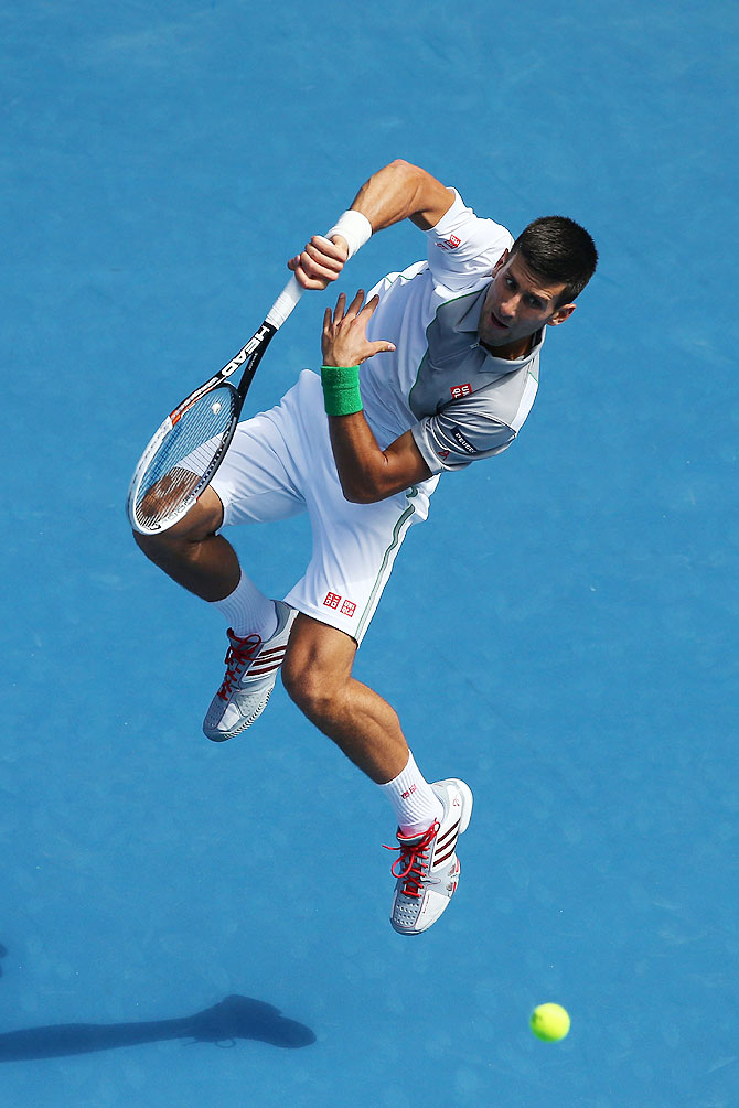 Novak Djokovic of Serbia plays a forehand in his fourth round match against Fabio Fognini of Italy on Sunday