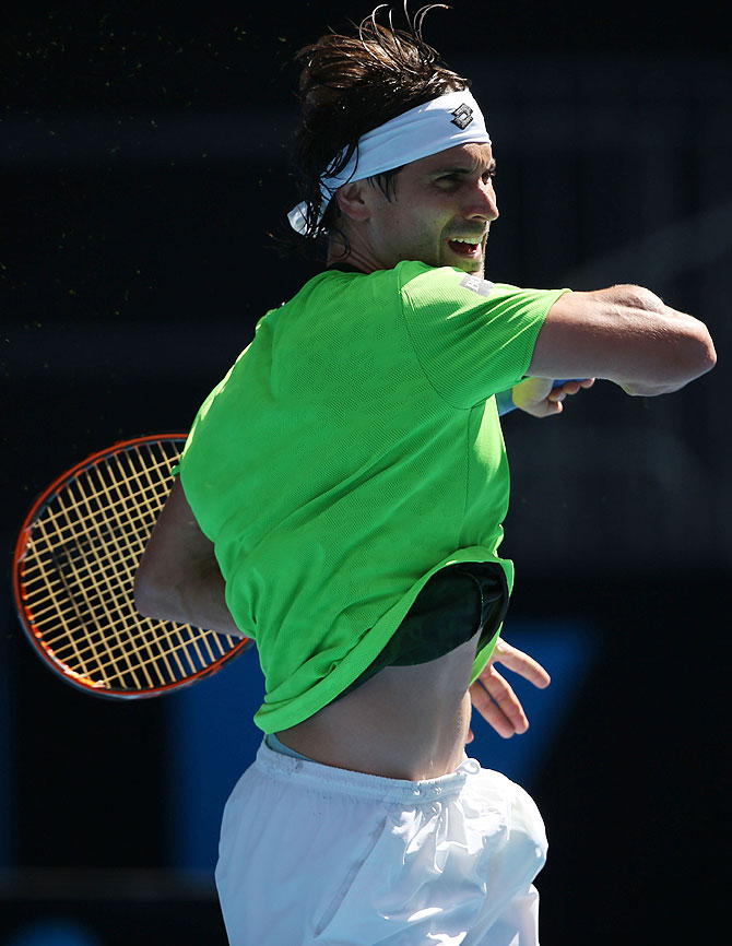 David Ferrer of Spain plays a forehand in his fourth round match against Florian Mayer of Germany on Sunday