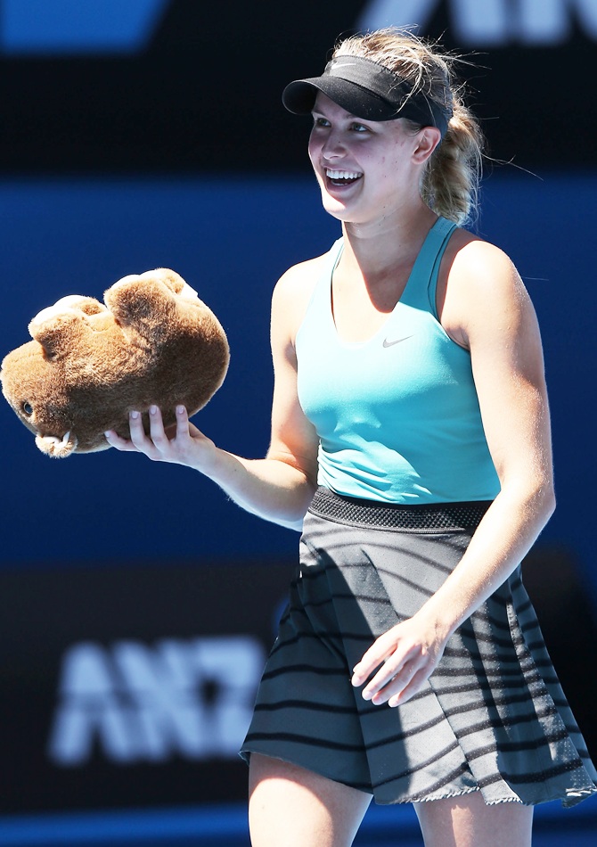 Eugenie Bouchard of Canada holds a toy wombat thrown to her from the crowd after winning her quarterfinal match