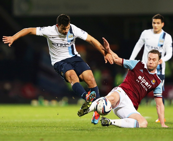Sergio Aguero of Manchester City is tackled by Kevin Nolan of West Ham United