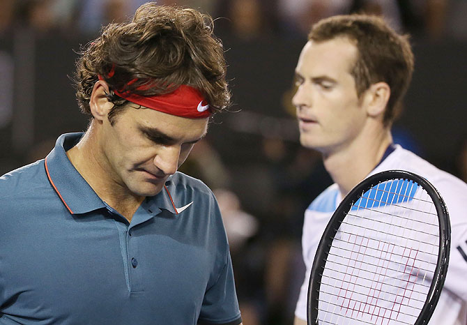 Roger Federer walks past Andy Murray