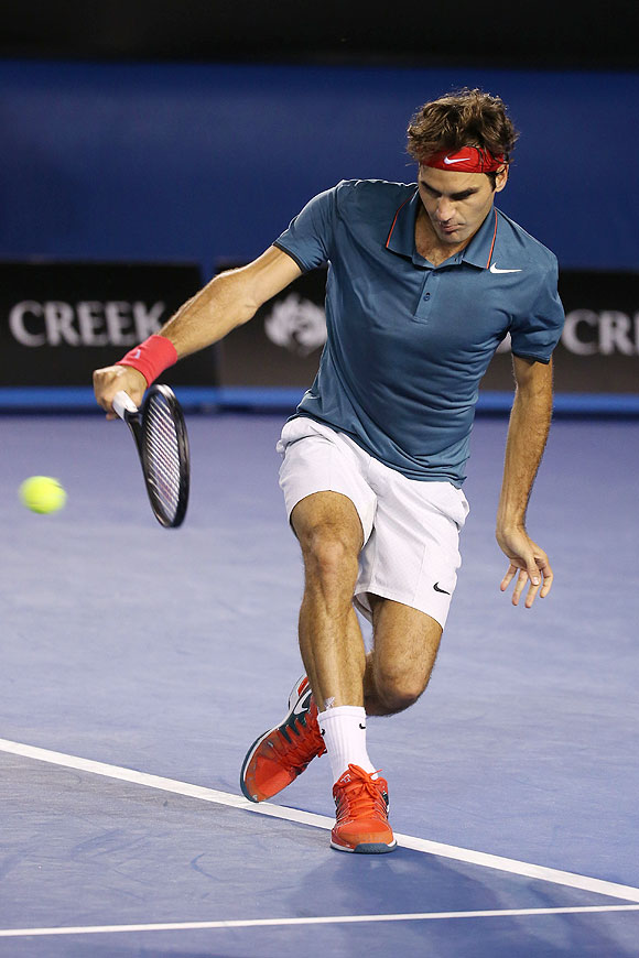 Roger Federer plays a backhand in his quarter-final match against Andy Murray