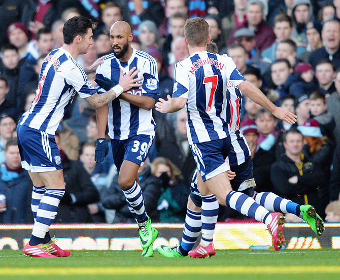 Nicolas Anelka of West Brom (centre) does the 'quenelle' salute' as he celebrates scoring a goal against West Ham United during their English Premier League match on December 28, 2013