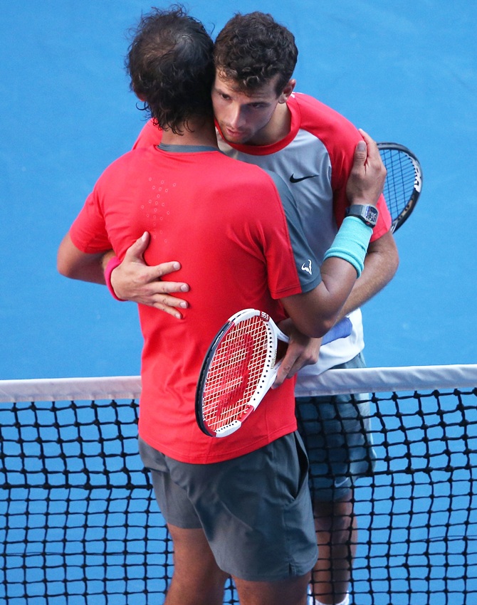 Grigor Dimitrov of Bulgaria and Rafael Nadal of Spain hug