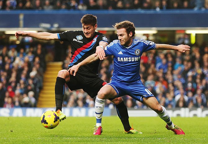 Joel Ward of Crystal Palace and Juan Mata of Chelsea challenge for the ball during the Barclays Premier League match