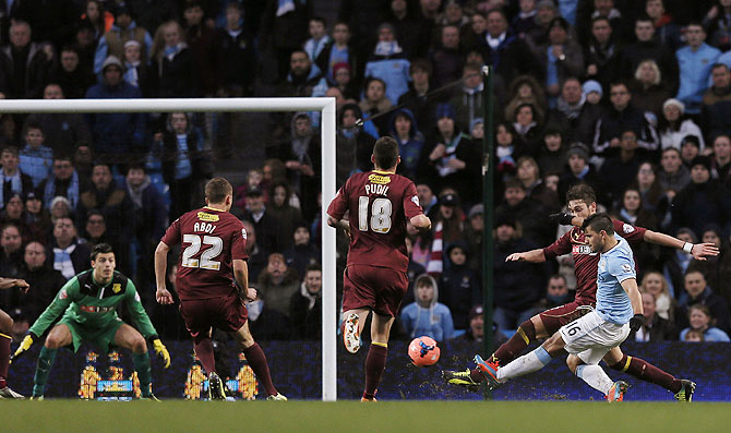 Manchester City's Sergio Aguero (right) scores his second goal against Watford during their English FA Cup fourth round match at the Etihad Stadium in Manchester on Saturday