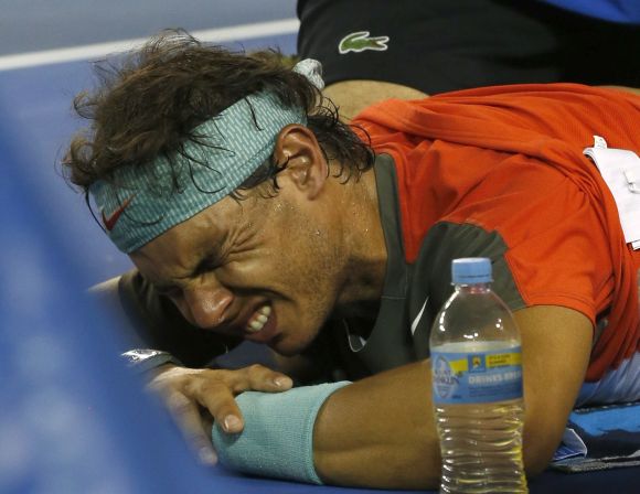 Rafael Nadal of Spain reacts as he receives treatment during his men's singles final match