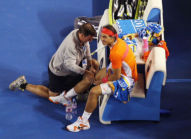 Rafael Nadal of Spain recieves medical attention between games in his quarterfinal match against Andy Murray of Great Britain during 2010 Australian Open