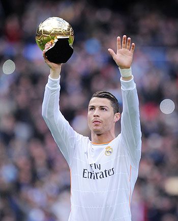 Cristiano Ronaldo of Real Madrid CF holds the Ballon d'Or 2013 award prior to he start of the La Liga match between Real Madrid CF and Granada CF at Santiago Bernabeu stadium on Saturday