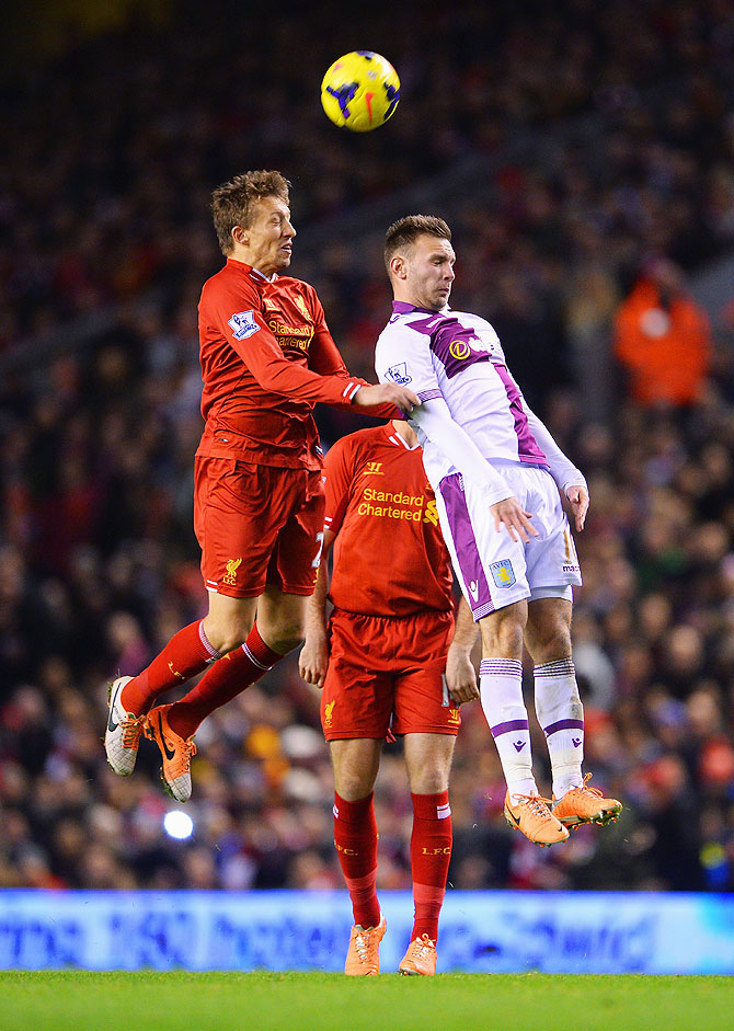 Lucas of Liverpool (left) and Andreas Weimann of Aston Villa vie for possession