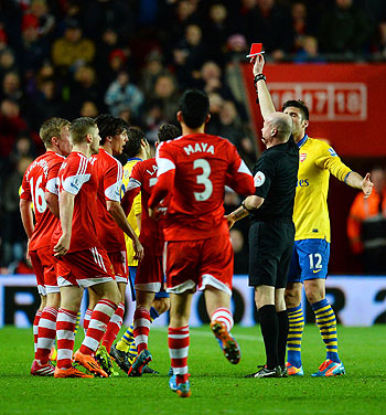 Referee Lee Mason shows Mathieu Flamini of Arsenal (obstructed) a red card during the E	English Premier League match between Southampton and Arsenal at St Mary's Stadium on Tuesday