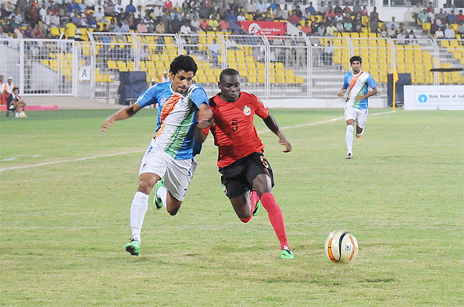 Goa (India's) Myron Fernandes and Mozambique's Osvaldo Sunde vie for possession