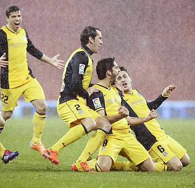 Atletico Madrid players celebrate a goal during their Spanish King's Cup match against Athletic Bilbao at San Mames stadium in Bilbao