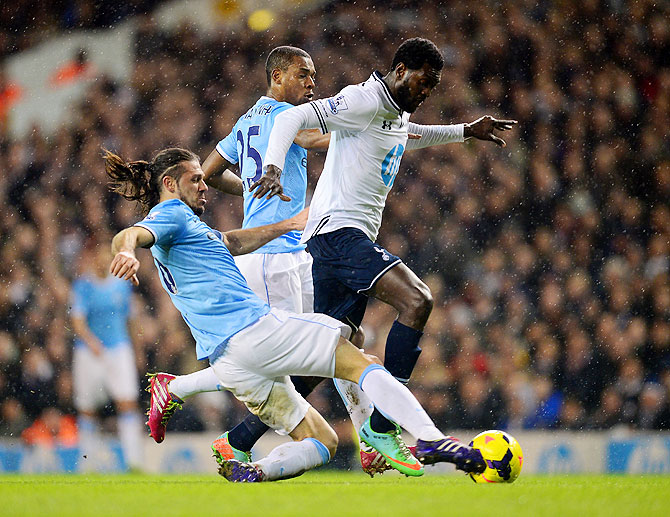 Martin Demichelis of Manchester City tackles Emmanuel Adebayor of Tottenham Hotspur
