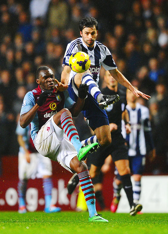 Christian Benteke of Aston Villa and Claudio Yacob of West Brom vie for the ball during their English Premier League match at Villa Park in Birmingham on Wednesday