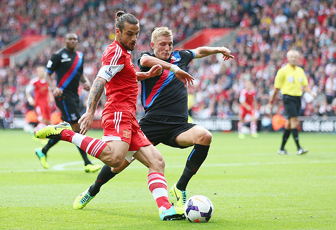 Dani Osvaldo of Southampton (left) battles for the ball with Dean Moxey of Crystal Palace 