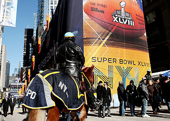A member of the NYPD on horseback looks on near the toboggan run at Super Bowl Boulevard in New York City on Thursday