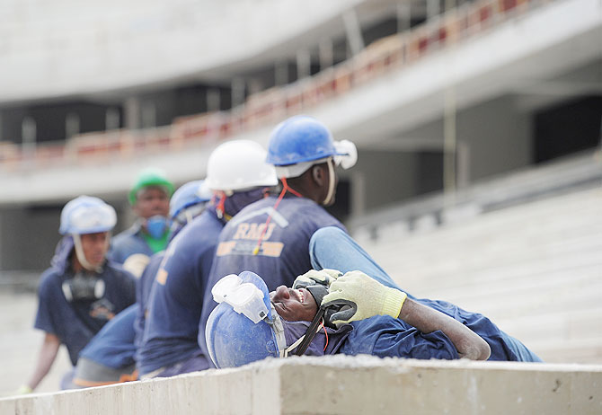 Workers from Haiti take a break at the Arena da Baixada