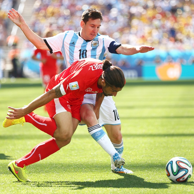 Ricardo Rodriguez of Switzerland challenges Lionel Messi of Argentina