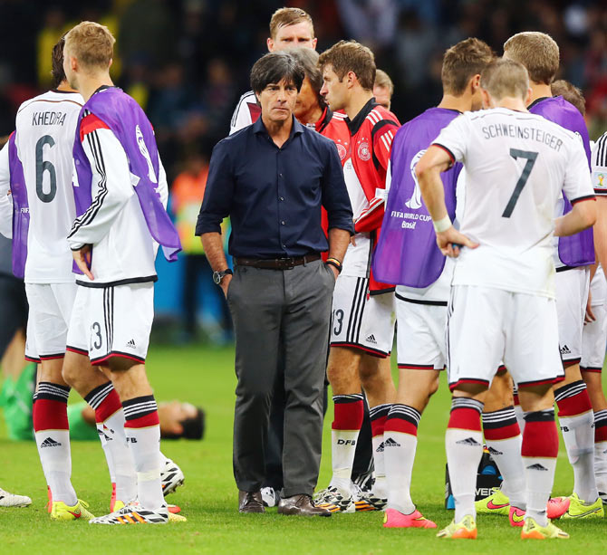 Head coach Joachim Loew of Germany looks on with his players in extra time on Monday